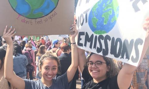 Students holding protest signs