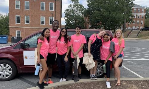 Students in front of minivan